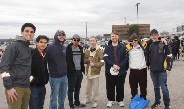 A group of MASS members standing together outdoors at a community event